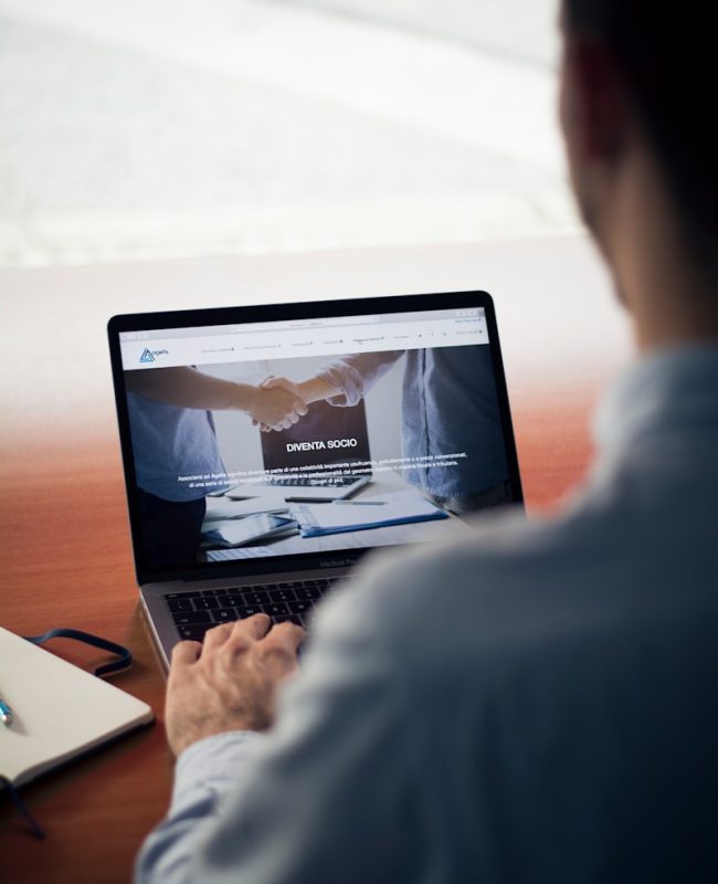 man operating the MacBook Pro